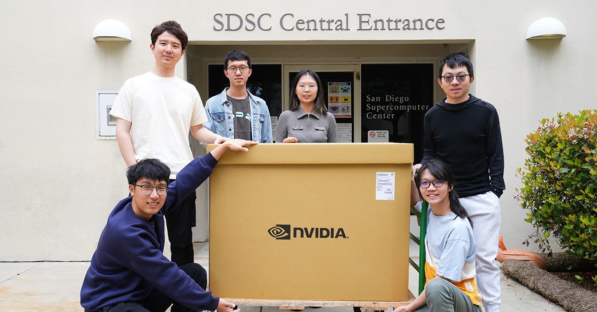 Members of the Hao Lab with the NVIDIA gift, still boxed, outside of SDSC.
