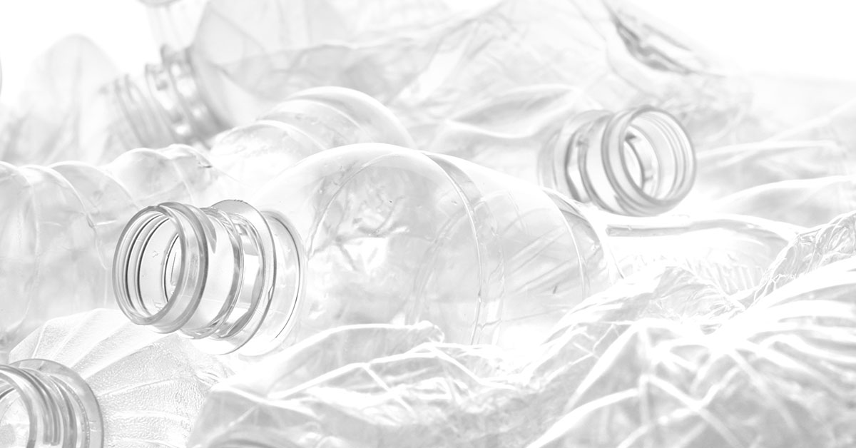 Pile of clear empty plastic water bottles.